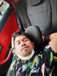 Portrait of man sitting in car