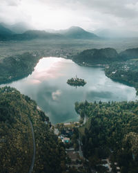 High angle view of sea and mountains against sky