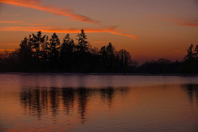 Scenic view of lake against romantic sky at sunset