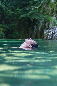 Woman swimming in pond