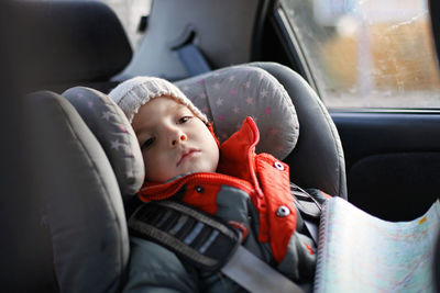 Portrait of cute baby in car