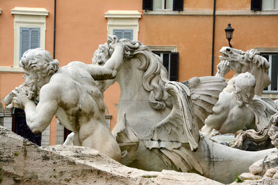 Statue against building in city