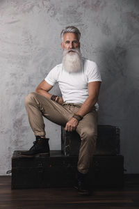 Portrait of man sitting on hardwood floor