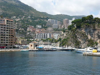 Boats in river with buildings in background