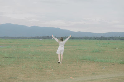 Full length of man standing on field against sky