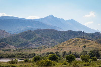 Scenic view of landscape and mountains against sky