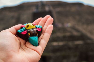 Cropped hand holding colorful toy