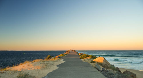 Scenic view of sea against clear sky during sunset