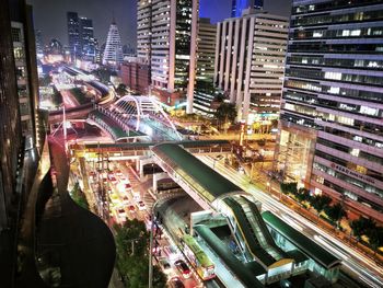 High angle view of city lit up at night