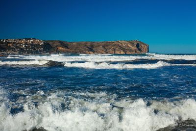 Scenic view of sea against clear blue sky