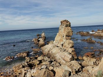 Rocks on beach against sky