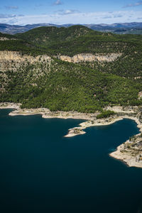 Aerial view of land and lake against sky