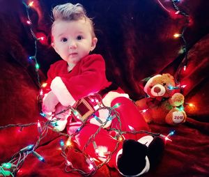 Boy in illuminated christmas tree