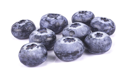 Close-up of blueberries against white background