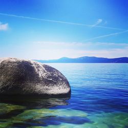 Scenic view of sea against blue sky