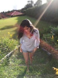 Young woman walking on field