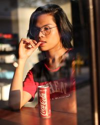 Beautiful young woman drinking glass