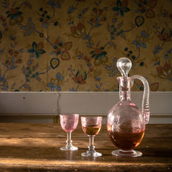 Carafe with two glasses in a vintage interior