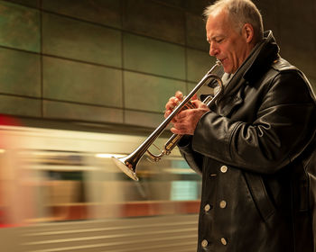 Side view of a man playing guitar