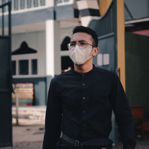 Portrait of young man wearing sunglasses standing outdoors