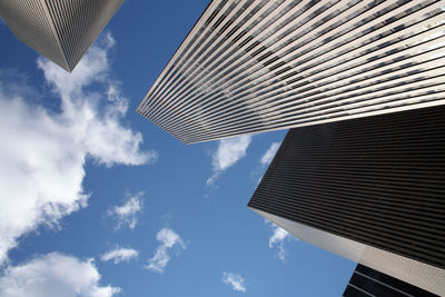 Low angle view of modern building against cloudy sky