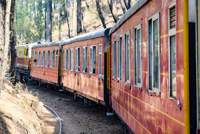 Kalka shimla toy train moving on mountain slopes, beautiful view, one side mountain, one side valley