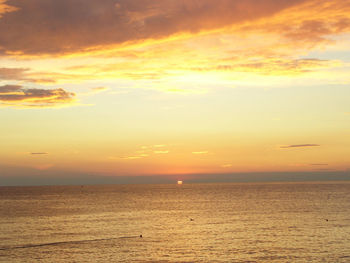 Scenic view of sea against orange sky