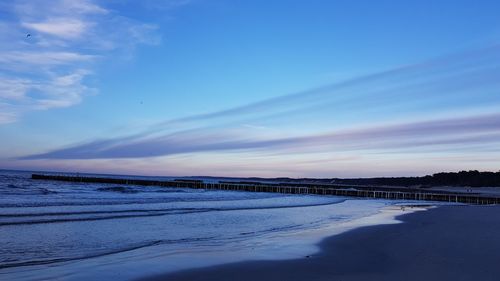 Scenic view of river against sky during winter