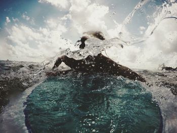 Man paddling on surfboard in sea