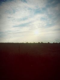 Scenic view of field against sky at sunset