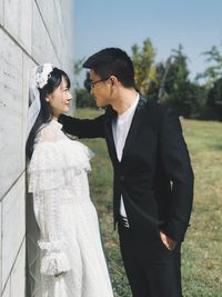 Side view of couple standing outdoors