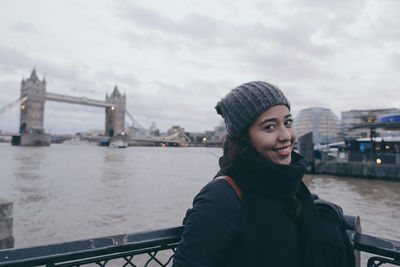 Woman standing on bridge over river