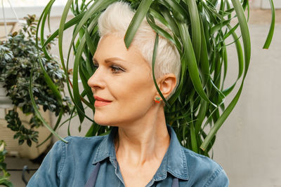 Botanical garden, woman with short hair. growing flowers concept