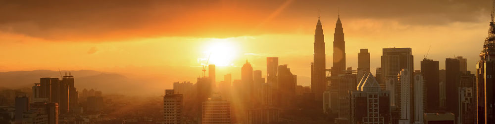 View of skyscrapers in city during sunset