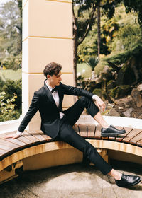 Full length of woman sitting at park