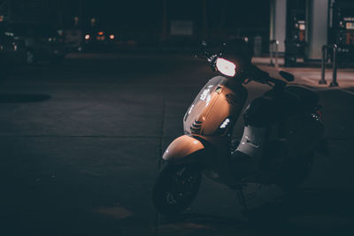 Motor scooter on street at night