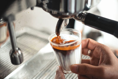 Close-up of hand holding coffee cup