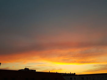 Silhouette buildings against sky during sunset