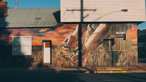 Side view of graffiti on building by street