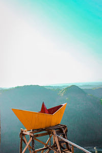 Traditional windmill by sea against clear sky