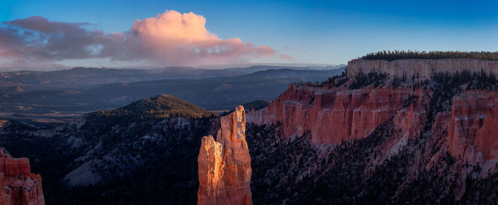 Panoramic view of mountains against cloudy sky