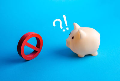 Close-up of piggy bank on blue background