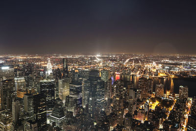 Aerial view of city lit up at night