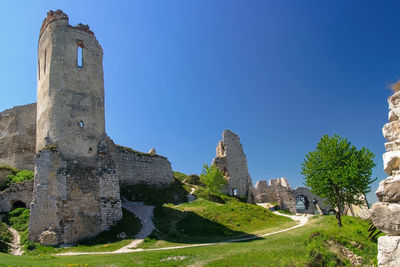 Low angle view of historic building against clear blue sky