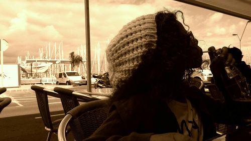 Rear view of woman sitting on table in restaurant