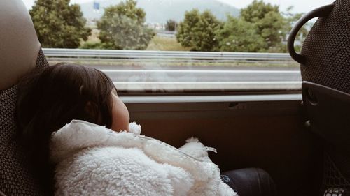Tired girl sleeping in bus