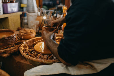 Midsection of man preparing food