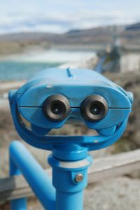 Close-up of coin-operated binoculars on beach