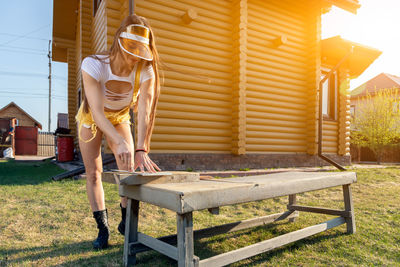 Man with umbrella on table in yard