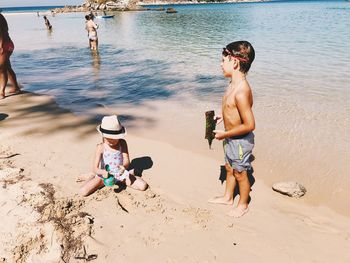 Full length of shirtless boy on beach